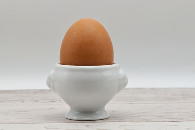 Fresh egg in an eggcup isolated on white background. traditional food for healthy breakfast.