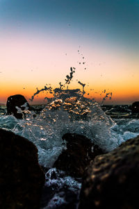 Close-up of sea against sky during sunset