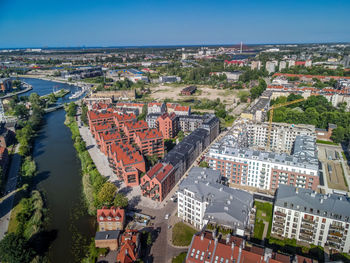 High angle view of river amidst buildings in city against sky