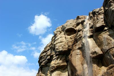 Low angle view of waterfall against sky