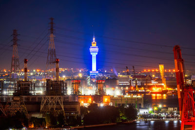 Illuminated buildings in city against sky at night