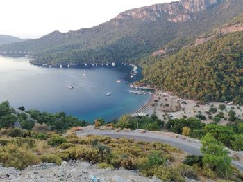 High angle view of sea and mountains against sky