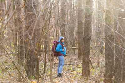 Rear view of man walking in forest