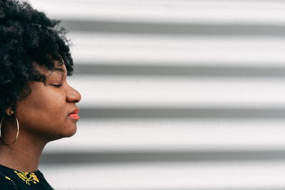 Close-up of woman with eyes closed by shutter