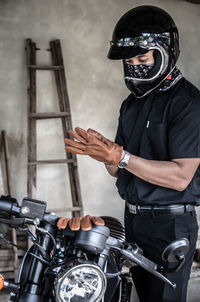 Man wearing gloves by motorcycle