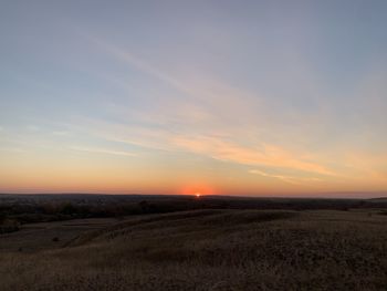 Scenic view of field against sky during sunset