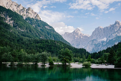 Scenic view of lake and mountains against sky