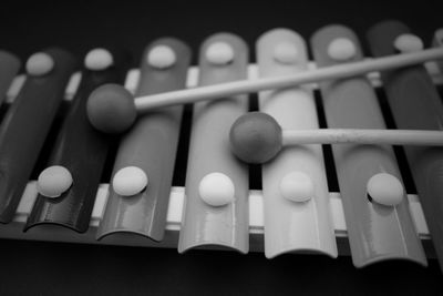 Close-up of toy xylophone against black background