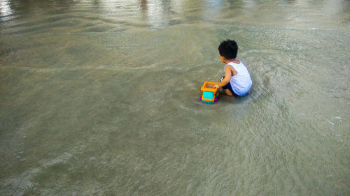High angle view of boy sitting at toy