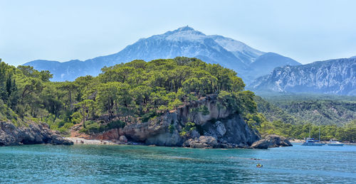 Scenic view of sea and mountains against sky