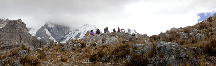 Panorama of snowy mountains and summit in the remote cordillera huayhuash circuit with local people.