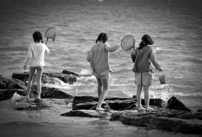 Friends fishing in sea