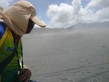 Rear view of man working in water
