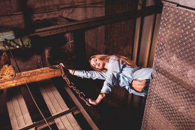 Full length of woman standing against window