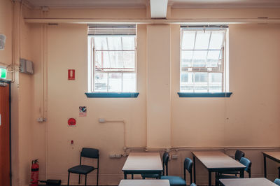 Empty chairs and tables in building