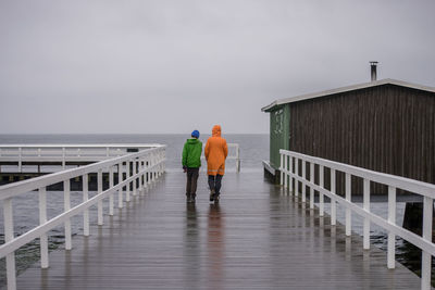 Rear view of woman standing on jetty