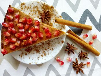 Close-up of pomegranate seeds on dessert in plate on table