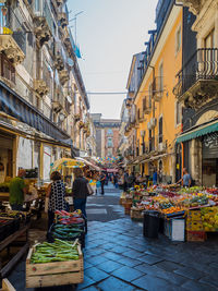 Street amidst buildings in city market of catania