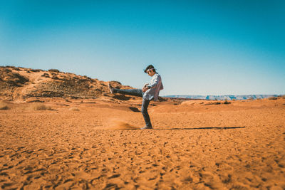 Side view of person on sand dune