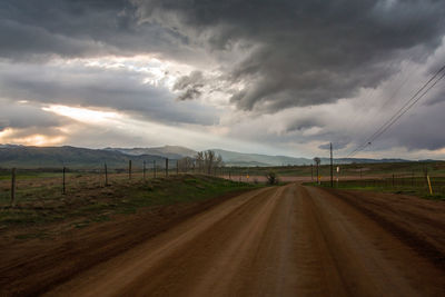 Empty road along countryside landscape