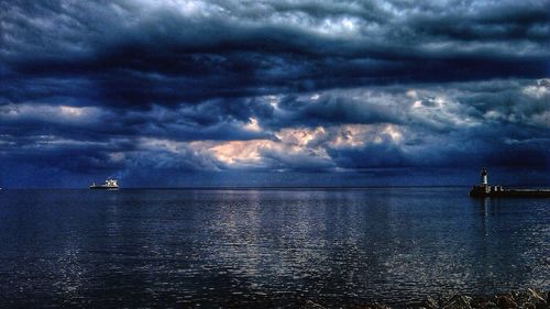 Scenic view of sea against cloudy sky