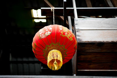 Close-up of illuminated lantern hanging against building