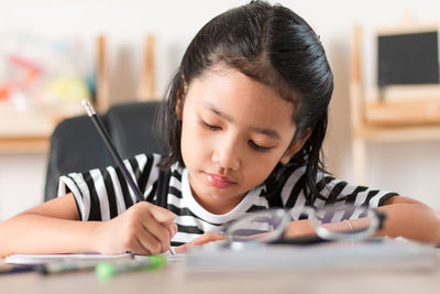 Portrait of girl looking at camera at home