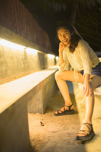 Portrait of smiling woman sitting outdoors