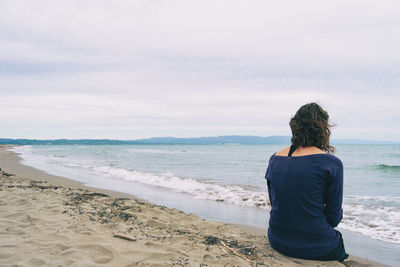 Rear view of man standing on beach