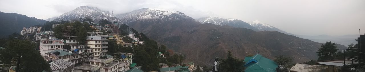 Houses against mountain range