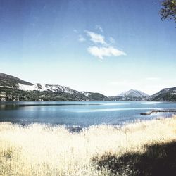 Scenic view of lake against sky during winter