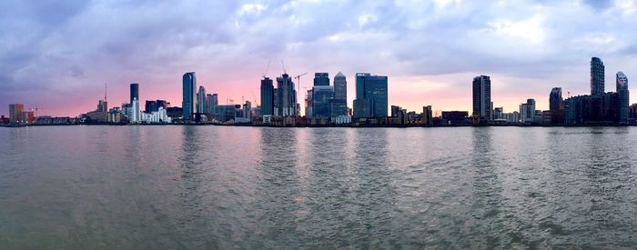 City at waterfront during sunset