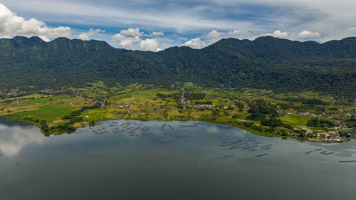 Scenic view of lake and mountains against sky