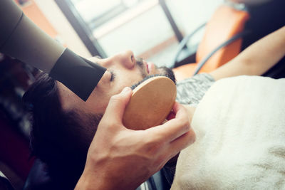 Barber grooming customer at shop