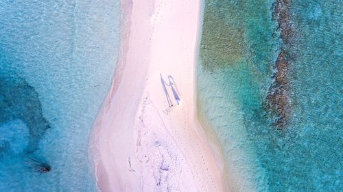 Shadow of husband and wife on island