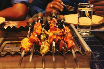 Close-up of preparing food on barbecue grill