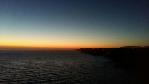 Scenic view of sea against clear sky during sunset