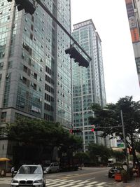 View of city street and buildings against sky