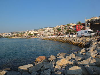 Town by sea against clear sky