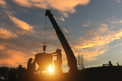 Construction worker grabs a pocket of cement on the building's upper floors.