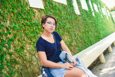 Asian girl in holiday smile relaxation in nature , green park resting among grass and flowers