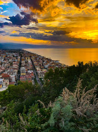 Aerial view of townscape against sky at sunset