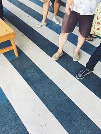 Low section of people walking on road