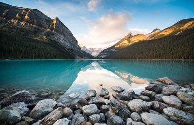 Scenic view of lake by mountains against sky