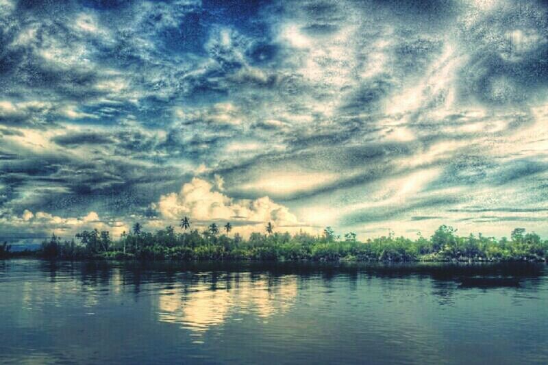 water, sky, cloud - sky, waterfront, cloudy, tranquility, tranquil scene, lake, scenics, cloud, beauty in nature, reflection, nature, river, weather, idyllic, tree, overcast, outdoors, no people