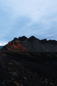 Scenic view of mountains against cloudy sky