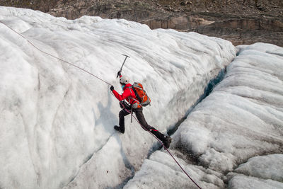 Person climbing on rock formation