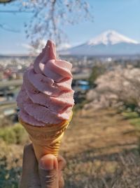 Close-up of hand holding ice cream