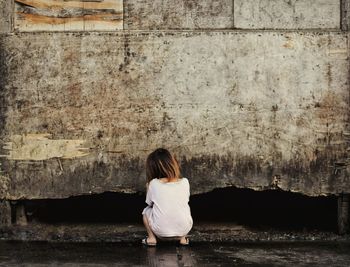 Rear view of a man sitting outdoors