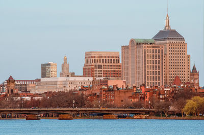 Buildings in city against clear sky